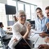 Mature woman with young office workers